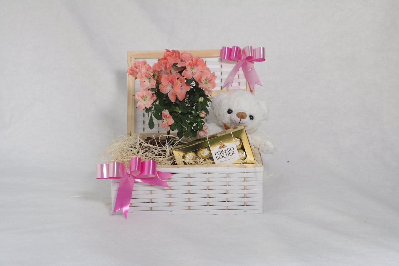 Beautiful gift basket featuring flowers, teddy bear, and chocolates for a special occasion.